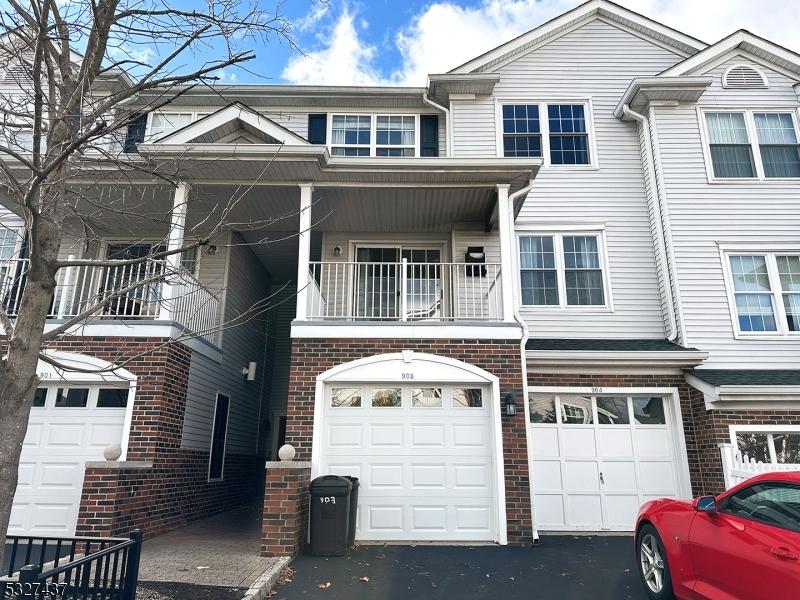 multi unit property with a balcony and a garage