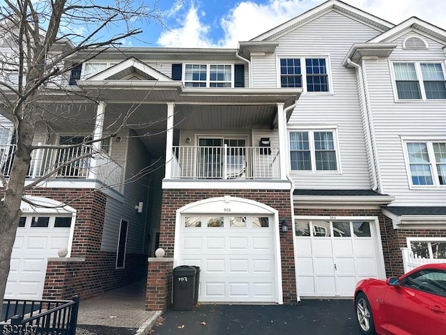 multi unit property with a balcony and a garage