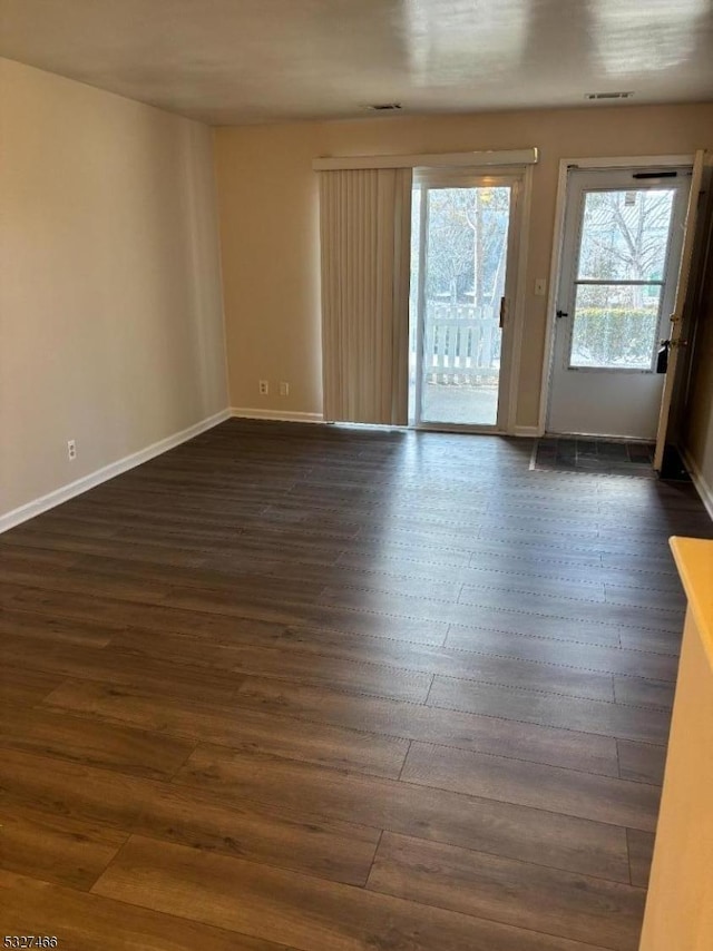 unfurnished room featuring dark wood-type flooring