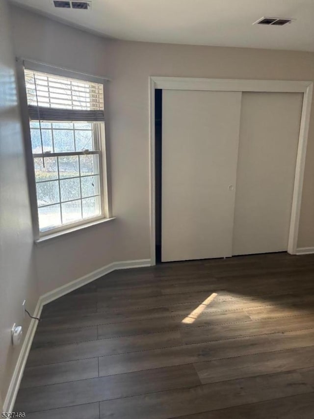 unfurnished bedroom featuring dark wood-type flooring