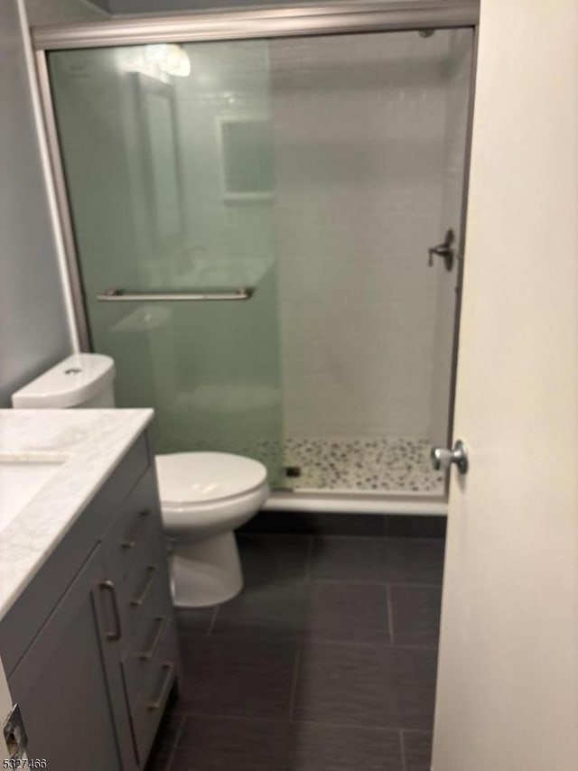 bathroom with vanity, tile patterned flooring, and walk in shower