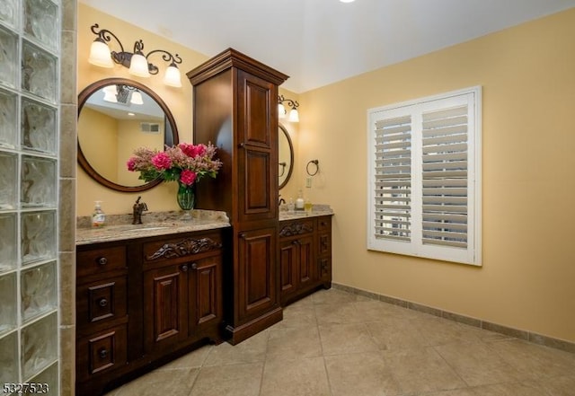 bathroom with tile patterned flooring and vanity