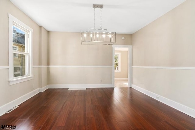 unfurnished dining area with dark hardwood / wood-style flooring