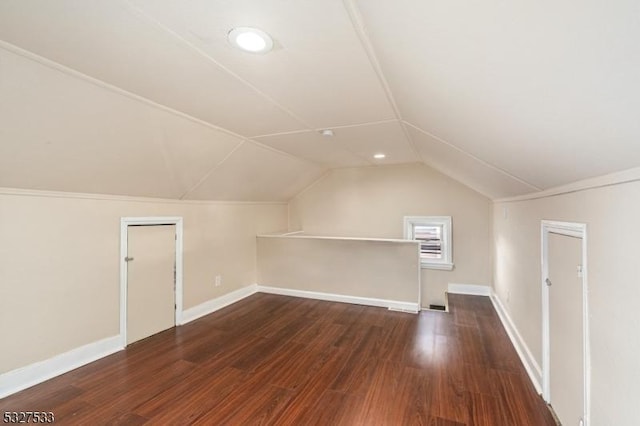 bonus room featuring dark hardwood / wood-style floors and vaulted ceiling