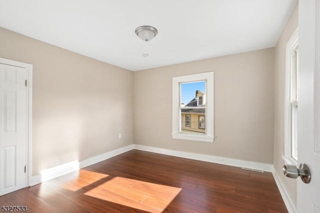 unfurnished room with hardwood / wood-style flooring