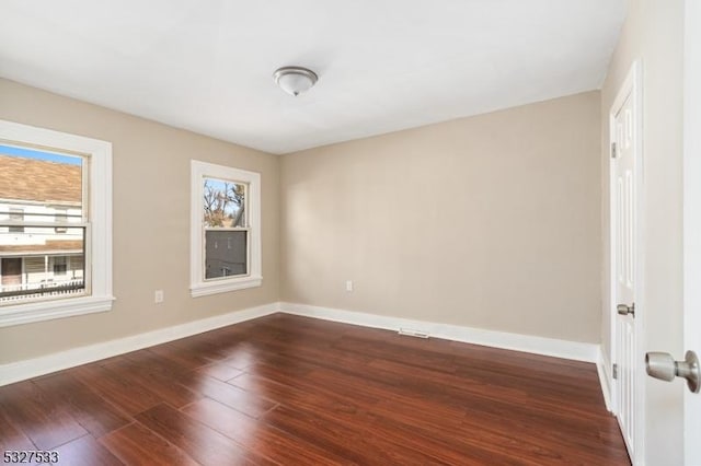 unfurnished room featuring dark wood-type flooring