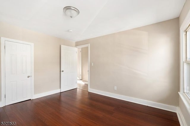 unfurnished bedroom featuring dark hardwood / wood-style floors