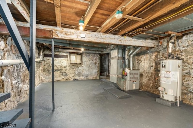 basement featuring heating unit and water heater