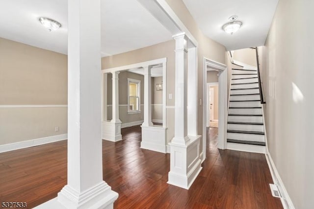 interior space with ornate columns and dark wood-type flooring