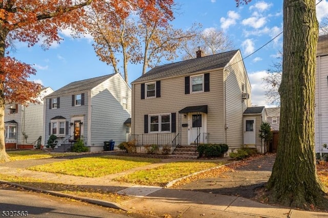 colonial-style house featuring a front yard