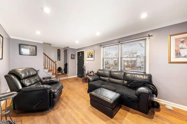 living room with light hardwood / wood-style floors and crown molding