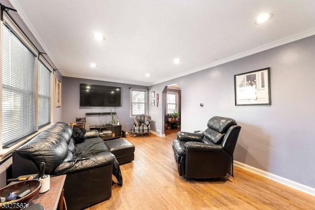 living room with ornamental molding and light wood-type flooring