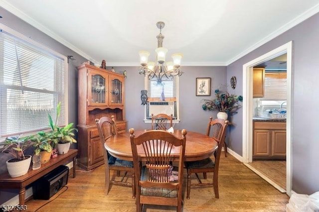 dining space featuring a chandelier, a wealth of natural light, crown molding, and wood-type flooring