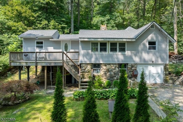 back of house featuring a yard and a deck