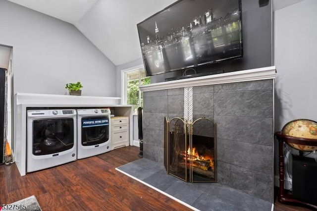 laundry room featuring separate washer and dryer, a fireplace, and dark hardwood / wood-style flooring