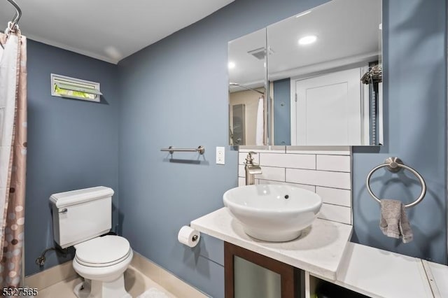 bathroom featuring tile patterned floors, vanity, tasteful backsplash, and toilet