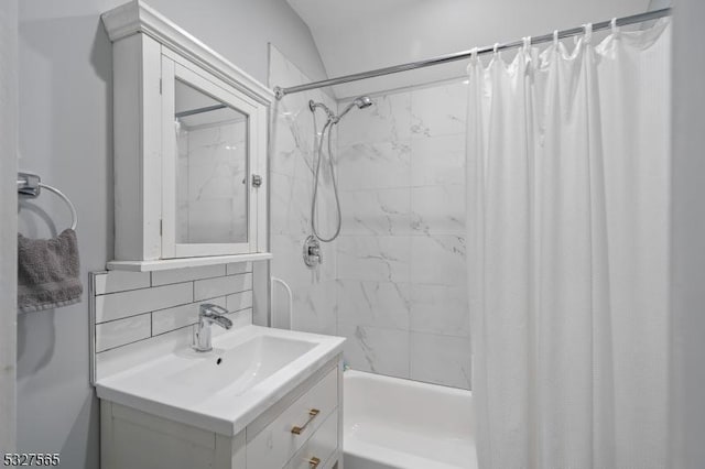 bathroom with vanity, shower / tub combo, and backsplash