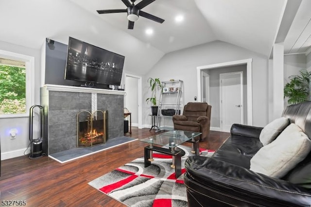 living room featuring a tile fireplace, ceiling fan, dark hardwood / wood-style floors, and lofted ceiling