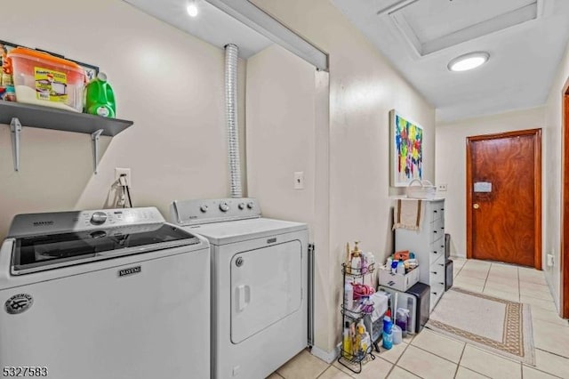 laundry area featuring washing machine and dryer and light tile patterned floors