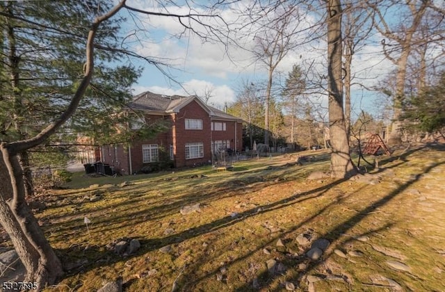 view of property exterior with a lawn