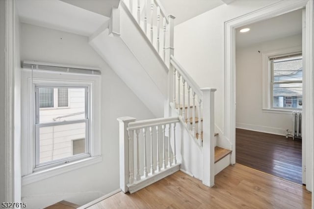 stairs with radiator and hardwood / wood-style floors