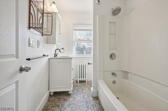 bathroom featuring radiator heating unit,  shower combination, and sink