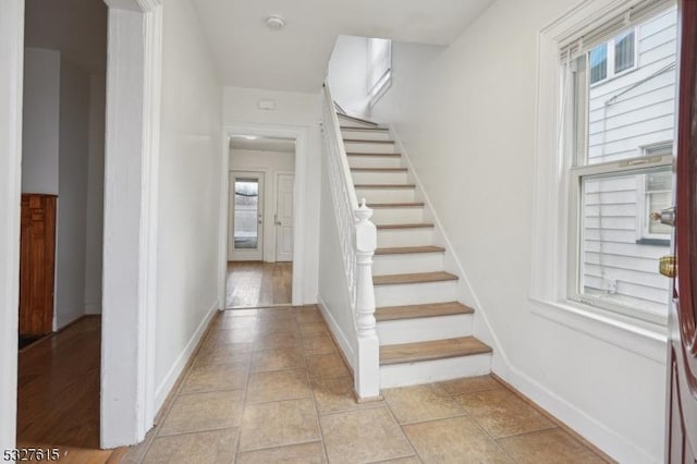 stairs with hardwood / wood-style floors