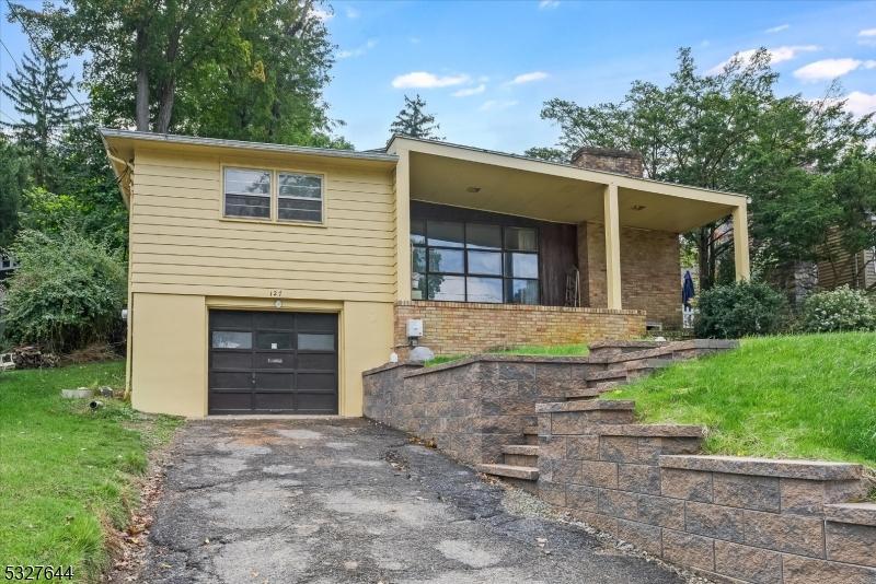 view of front facade with a garage and a front lawn