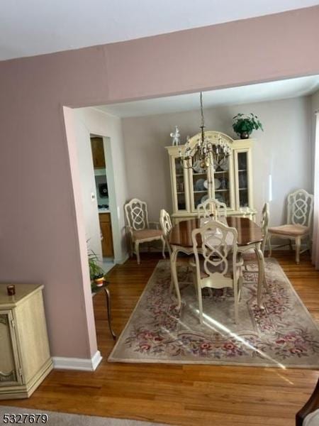 dining room featuring a chandelier and hardwood / wood-style flooring