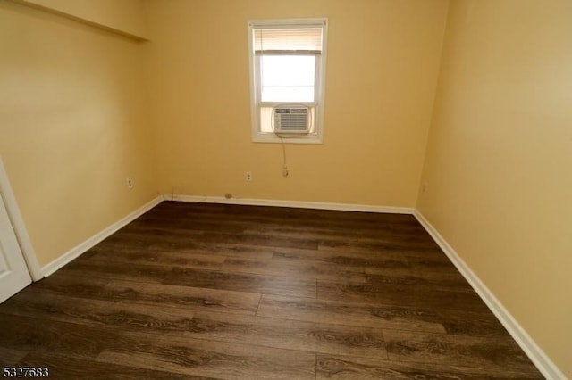 empty room with dark hardwood / wood-style flooring and cooling unit