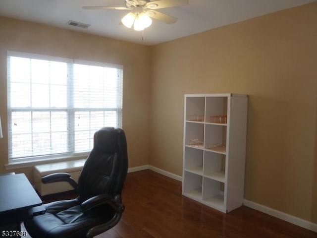 office with ceiling fan and dark wood-type flooring