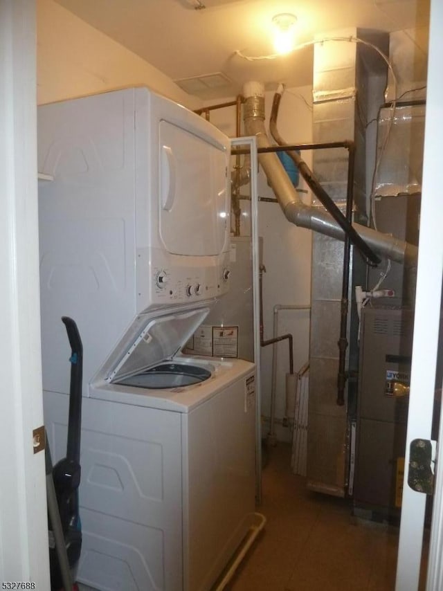 laundry area with stacked washer and clothes dryer