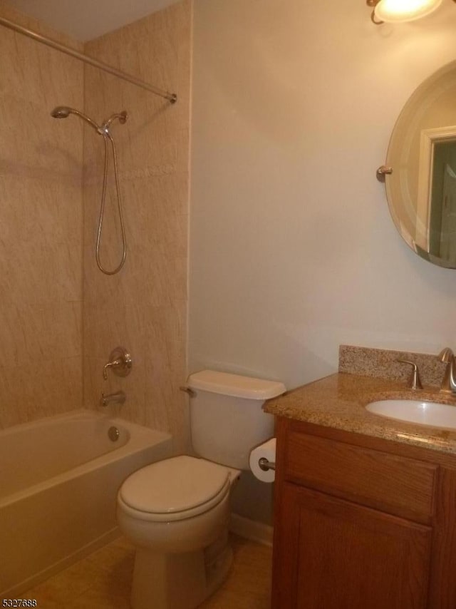 full bathroom featuring toilet, tile patterned floors, vanity, and tiled shower / bath combo