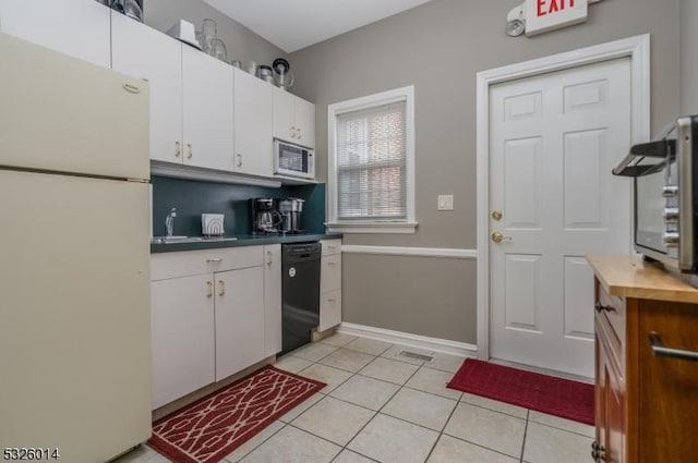 kitchen featuring white cabinetry, white appliances, sink, and light tile patterned floors