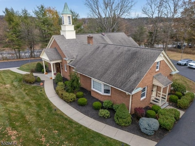 view of side of home with a yard