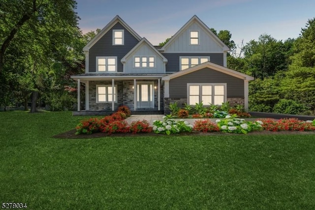 view of front of home featuring covered porch and a yard