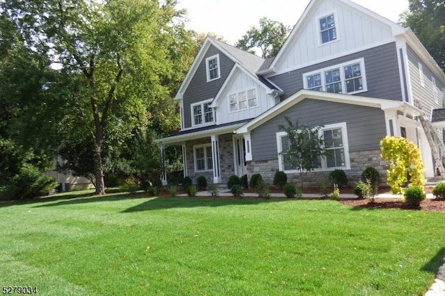 view of front of home with covered porch and a front lawn