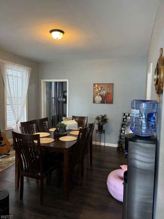 dining space with dark hardwood / wood-style floors