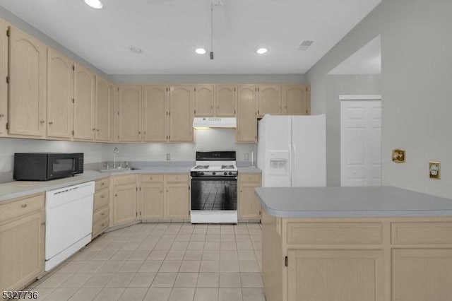 kitchen featuring light brown cabinets, white appliances, and sink