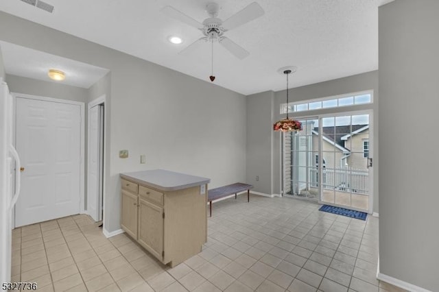 kitchen featuring light tile patterned floors, decorative light fixtures, ceiling fan, and light brown cabinetry