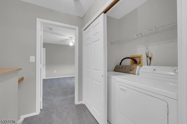 laundry room featuring a textured ceiling, ceiling fan, light carpet, and washing machine and clothes dryer