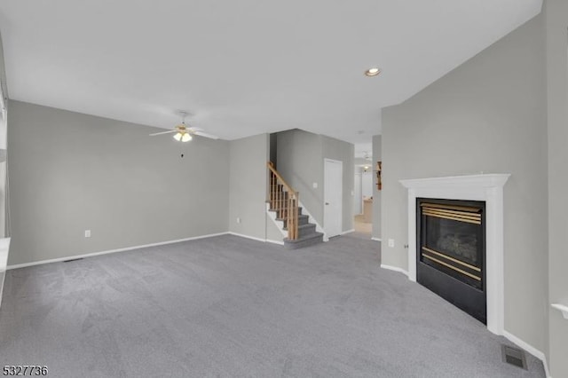 unfurnished living room with carpet flooring and ceiling fan