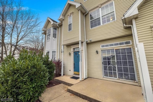 property entrance featuring a patio area