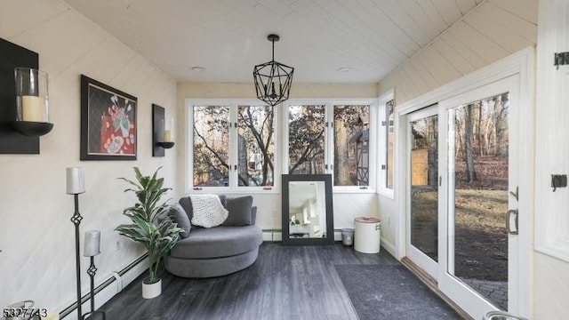 sunroom / solarium with an inviting chandelier and a baseboard radiator