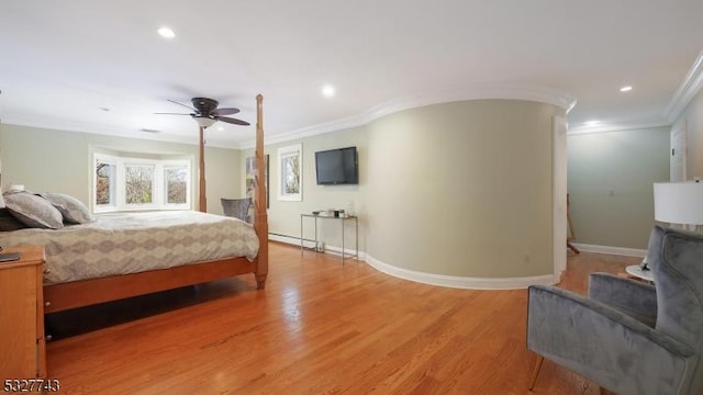 bedroom featuring ornamental molding, light wood-type flooring, a baseboard heating unit, and ceiling fan