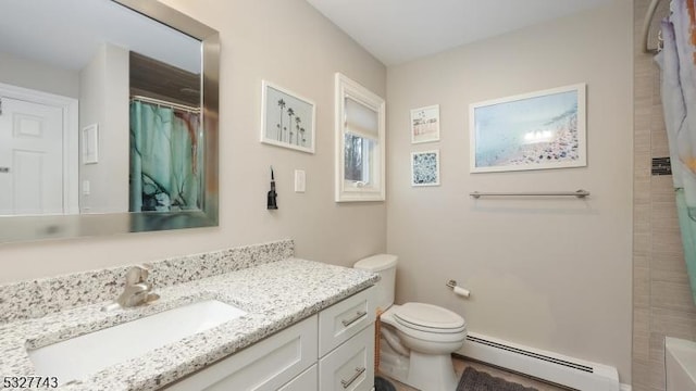 bathroom with toilet, vanity, and a baseboard heating unit