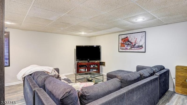 living room with a paneled ceiling and hardwood / wood-style floors