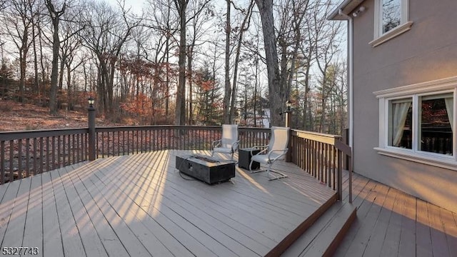 wooden deck featuring an outdoor fire pit