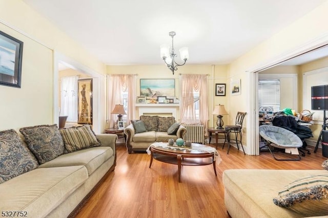 living room featuring hardwood / wood-style floors and an inviting chandelier