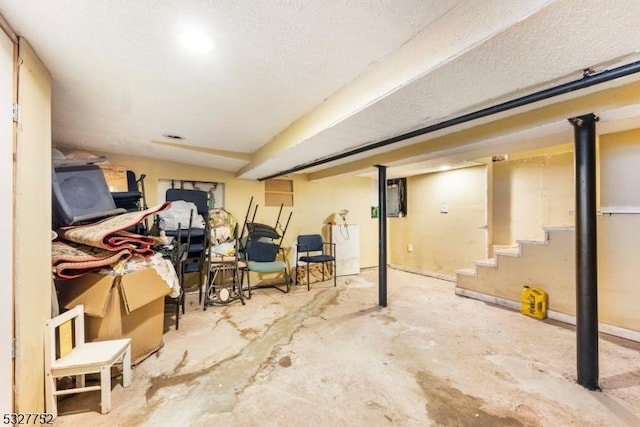 basement featuring a textured ceiling